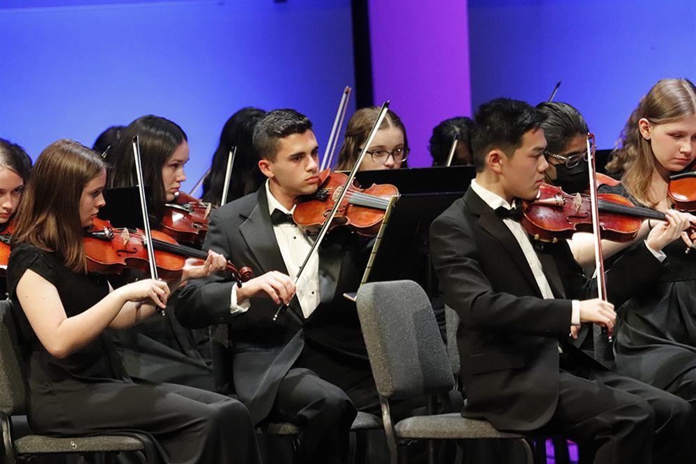 Students from the NAI & NASH Orchestra perform at their spring concert.